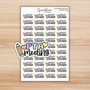 May include: A sticker sheet featuring multiple rows of small, colorful planner stickers. Each sticker displays a yellow pencil icon, a pink heart, and the text PTA Meeting in black script. A larger, die-cut version of the same sticker is placed on top.