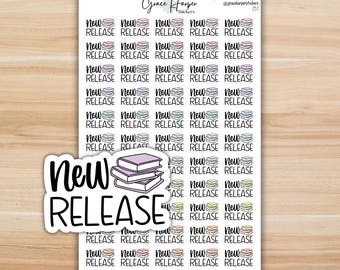 May include: A sticker sheet featuring multiple rows of small, colorful book icons with the text NEW RELEASE printed in black. A larger, die-cut sticker of the same design is layered over the bottom left corner of the sheet, showing three stacked books.