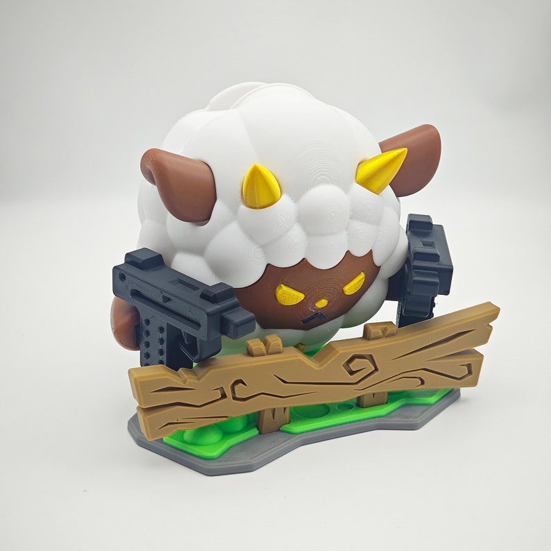 May include: A white sheep with brown ears and horns, holding two black guns, standing on a brown wooden fence. The sheep has angry yellow eyes and a brown face.