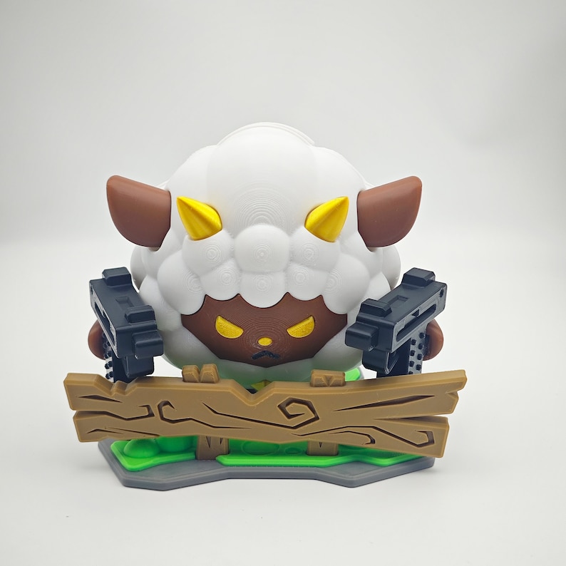 May include: A white sheep with brown ears and horns holding two black guns, standing behind a brown wooden fence. The sheep has angry yellow eyes and a brown face.