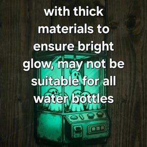 May include: A green glow-in-the-dark sticker of a ghost-filled claw machine. The sticker has the text "sticker is made with thick materials to ensure bright glow, may not be suitable for all water bottles".