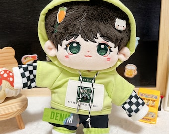 May include: A green hooded sweatshirt with a checkered sleeve, black pants, and green and white socks with buttons. The sweatshirt has a patch with the text "ITS NOW DESIGN FOR YOU" and a small patch with the text "NULL STUDIO".