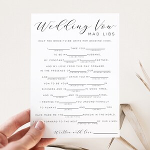 May include: A printable wedding vow mad libs game with fill-in-the-blank spaces for the bride-to-be to write her vows. The text reads "Wedding Vow Mad Libs Help the bride-to-be write her wedding vows."
