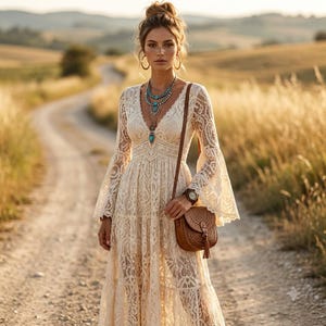 May include: A long-sleeved cream-colored lace dress with a V-neckline and flared sleeves. The dress features intricate floral patterns throughout the fabric. A brown leather crossbody bag with a tassel and a turquoise beaded necklace are worn.