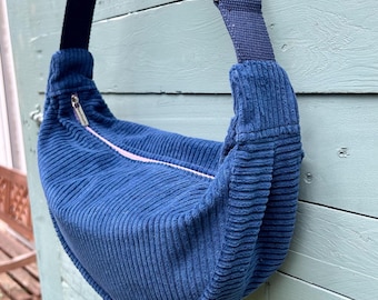 Navy corduroy round cross body bag, handmade from deadstock fabric. Fabulous flower power vintage lining. Two slip pockets. Upcycled & Eco.