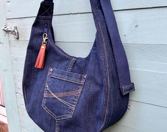 Denim jeans slouchy sling bag with spotty cotton lining. Upcycled from a pair of jeans.