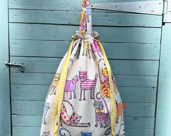 Large laundry bag, made from upcycled cotton fabric covered in colourful cats. Fully lined, with handles. Reclaimed, reusable. Handmade.