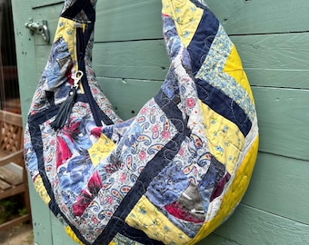 Slouchy boho vintage patchwork bag with vintage Laura Ashley lining. Adjustable patchwork strap. Zipped closure & slip pocket. Eco friendly.