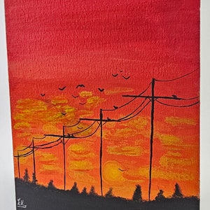 May include: A painting of a sunset with power lines and birds flying in the sky. The sky is a gradient of red, orange, and yellow. The power lines are black and the birds are silhouetted against the sky. The painting is signed "EK" in the bottom left corner.