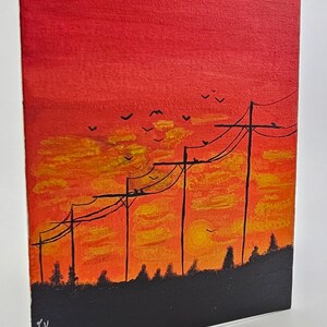 May include: A painting of a sunset with silhouetted trees and power lines. The sky is a vibrant orange and red with yellow clouds. Birds are flying in the sky.