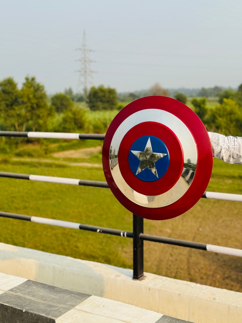 This shield is inspired by classic comic book heroes and features a bold red, white, and blue color scheme. Ideal for fans of patriotic superheroes, cosplay events, or collectors of fantasy-themed gear. Designed to resemble the iconic gear of a star-bearing super soldier, perfect for display or costume wear. This shield is not affiliated with any brand but made for fans of heroic legends and vintage comics