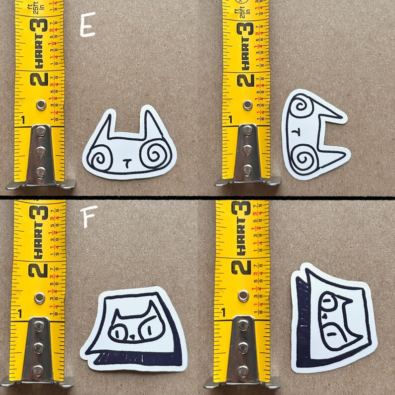 May include: Four black and white cat stickers on a brown background. The stickers are labeled "E" and "F".