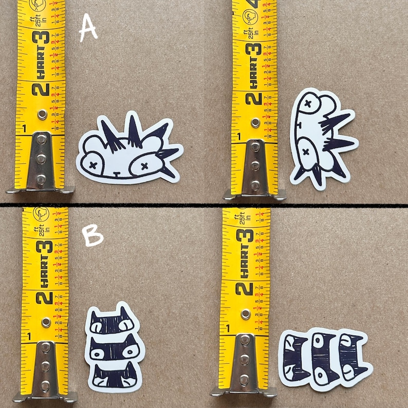 May include: Four black and white stickers with cartoon animal designs. The stickers are on a brown surface with a measuring tape on either side. The stickers are labeled A and B.