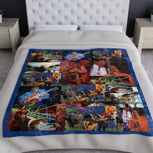 May include: A white and blue quilt with a collage of musicians playing instruments. The quilt features a variety of colors and patterns, including red, green, and yellow. The musicians are all wearing different clothes, and some are holding guitars, drums, and other instruments.