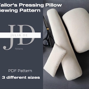 May include: A collection of off-white tailor's pressing pillows in various shapes and sizes, including a long cylindrical pillow, a rectangular pillow, and a smaller rectangular pillow. The image also includes a pair of black scissors. Text on the image reads "Tailor's Pressing Pillow Sewing Pattern" and "Julia De Patterns".
