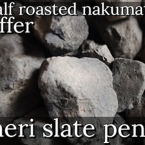 May include: Close-up of a pile of dark gray, irregularly shaped rocks. The text "Half roasted nakumatt Offer" is at the top of the image. The text "meri slate pen works" is at the bottom of the image.