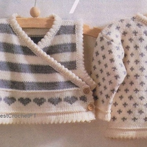 May include: Two knitted garments, a vest and a sweater, both in white with grey stripes and patterns. The vest has a criss-cross front and a row of hearts at the bottom. The sweater has a small, repeating pattern of grey crosses.