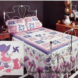 May include: A white iron bed frame with a pink and blue patchwork quilt. The quilt features a floral design and a girl with a cat. The text "Shop: The Sweetest Crochet" is visible in the bottom right corner of the image.