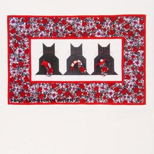 May include: Three black cats in suits with red accents are arranged in a row against a white background. The cats are surrounded by a red and white floral border. The text "Shop The Sweetest Crochet" is visible at the bottom of the image.