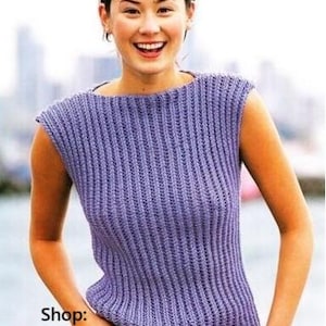 May include: A purple crochet sleeveless top with a boat neck. The top is made with a ribbed stitch. Shop: TheSweetestCrochetPT
