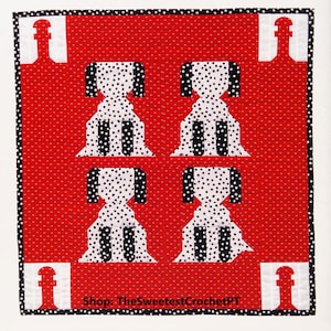 May include: A red and white quilt with a black and white polka dot pattern. The quilt features four dogs in a row, each with a black and white polka dot pattern. The quilt is bordered with a black and white polka dot pattern. The text "Shop: TheSweetestCrochetPT" is at the bottom of the quilt.