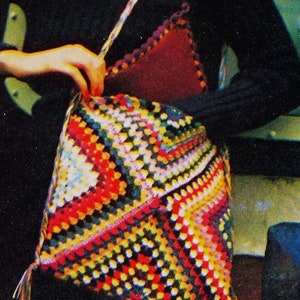 May include: A colorful crocheted bag with a geometric pattern in shades of red, yellow, green, and white. The bag has a long strap and a flap closure.