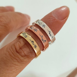 May include: Four rings in gold, rose gold, and silver, each engraved with a delicate floral design. The rings are displayed on a finger, showcasing their different colours and styles. The floral engravings add a touch of nature-inspired elegance.