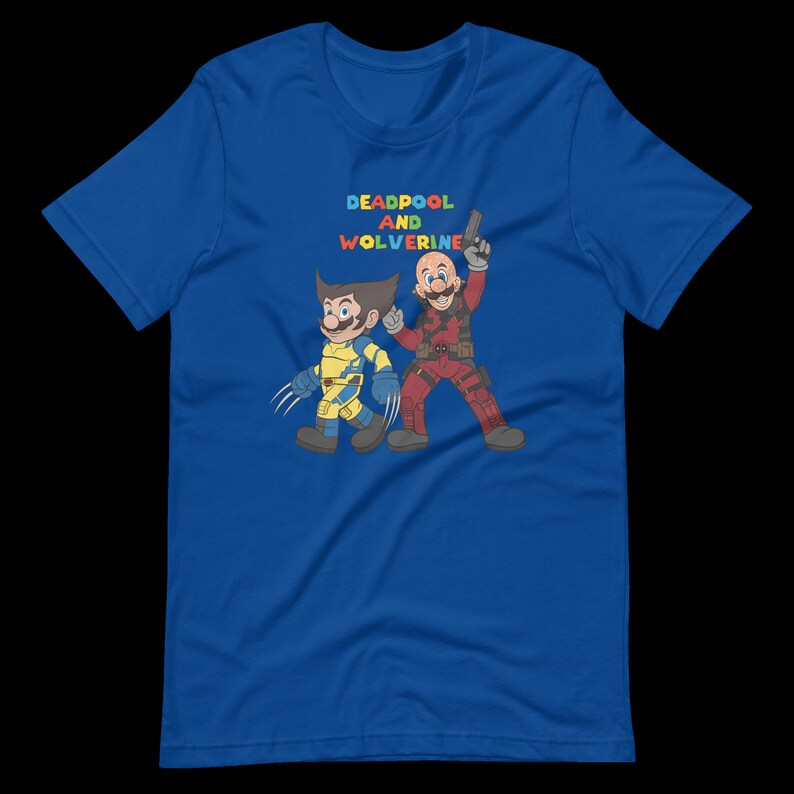May include: A blue t-shirt with a graphic of Deadpool and Wolverine. The text "DEADPOOL AND WOLVERINE" is printed in rainbow colors above the characters.