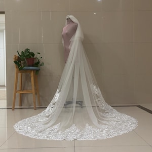 White, ivory, magnificent double layered wedding veil in the cathedral, romantic bridal veil