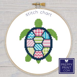 May include: A cross-stitch chart of a turtle with a navy blue outline and a shell composed of various patterned squares in shades of pink, blue, green, and yellow. The words "stitch chart" are above the turtle. The logo for "Preppy Print .com" is in the lower right corner.