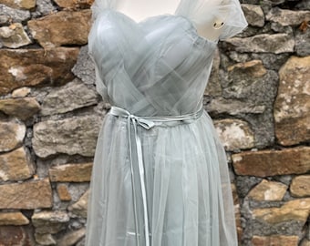 May include: A light blue tulle dress with a sweetheart neckline and a satin ribbon tie at the waist.