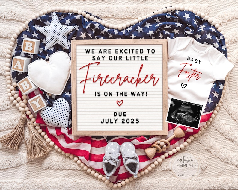 May include: A red, white, and blue American flag heart-shaped backdrop with a white letter board that reads "We are excited to say our little Firecracker is on the way! Due July 2025". There is a white onesie with the text "Baby Foster" in red, a small ultrasound image, a wooden rattle, and wooden blocks that spell "BABY".