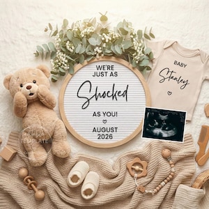 May include: A neutral-toned baby announcement featuring a teddy bear, letter board with the text "WE'RE JUST AS SHOCKED AS YOU!" and "AUGUST 2026", a onesie with the name "Stanley", and an ultrasound image. Other items include wooden blocks, shoes, and a pacifier.