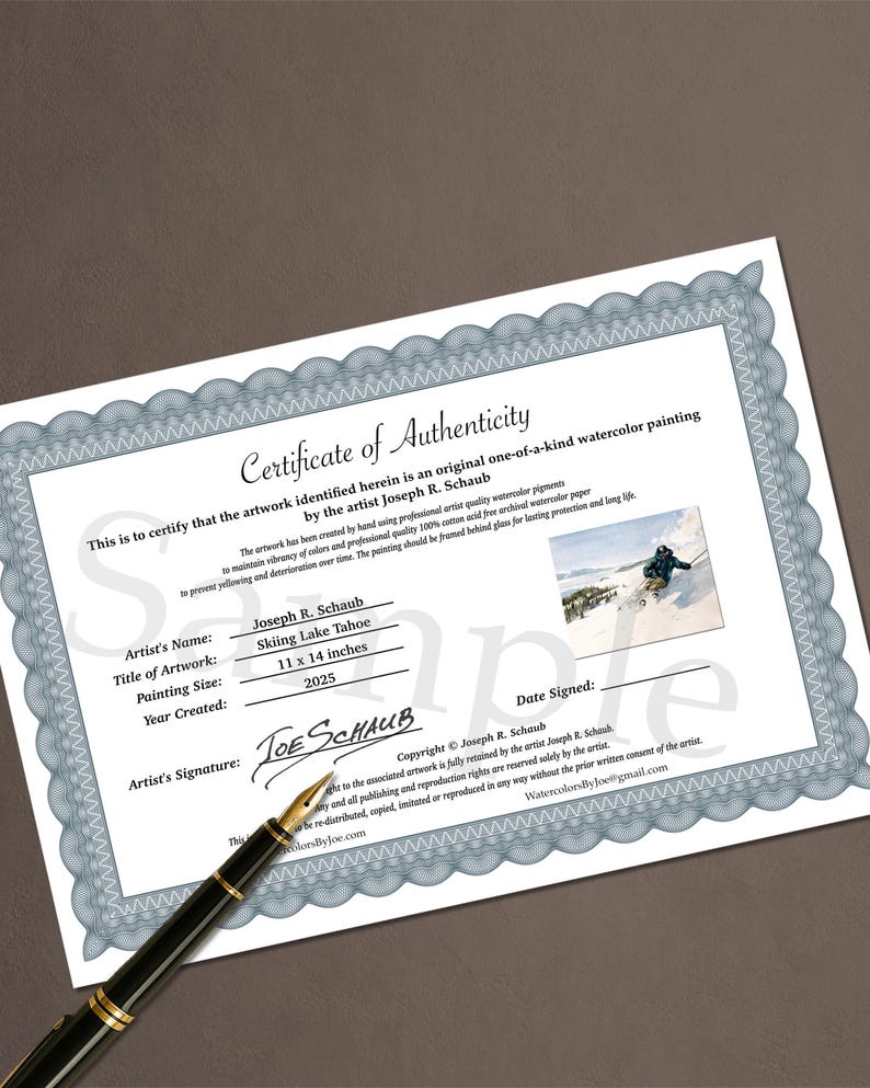 May include: A certificate of authenticity for a watercolor painting, featuring a blue and white border design. The certificate includes the artist's name, artwork title "Skiing Lake Tahoe", painting size 11 x 14 inches, and year created 2025. A black pen rests on the certificate.