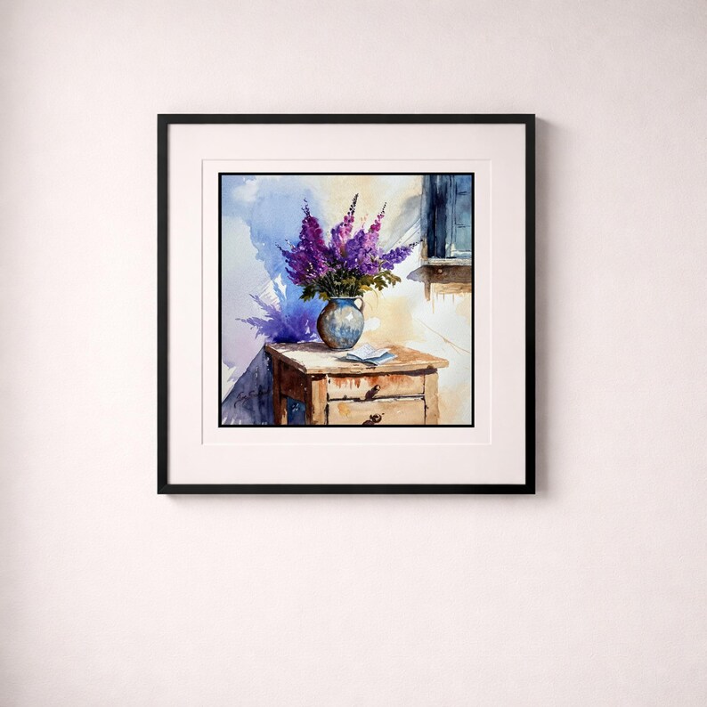 May include: Watercolor painting of a vase filled with purple flowers on a wooden table. The vase is blue and the table has two drawers. A window is visible in the background, and the painting is framed in black.
