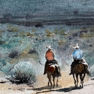 May include: Watercolour painting depicting two cowboys on horseback, seen from the rear, traversing a landscape. The riders are wearing hats and are dressed in shades of orange and blue. The background features a cloudy sky and muted green and brown tones.