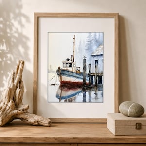 May include: A framed watercolor painting depicting a weathered blue and white fishing boat docked at a wooden pier. The scene includes a small building, a lone bird perched on a post, and a misty forest background, all rendered in soft tones.