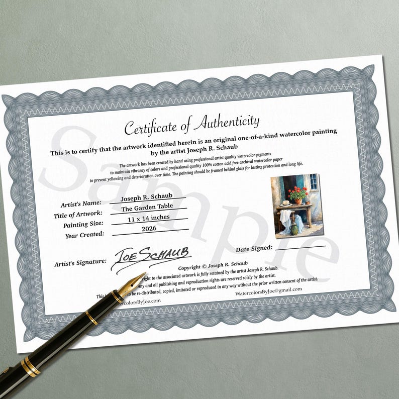 May include: A white Certificate of Authenticity document with a grey decorative border, featuring the text 'Certificate of Authenticity', artist name 'Joseph R. Schaub', title 'The Garden Table', size '11 x 14 inches', and a year '2026'. A black fountain pen lies across the bottom left corner.