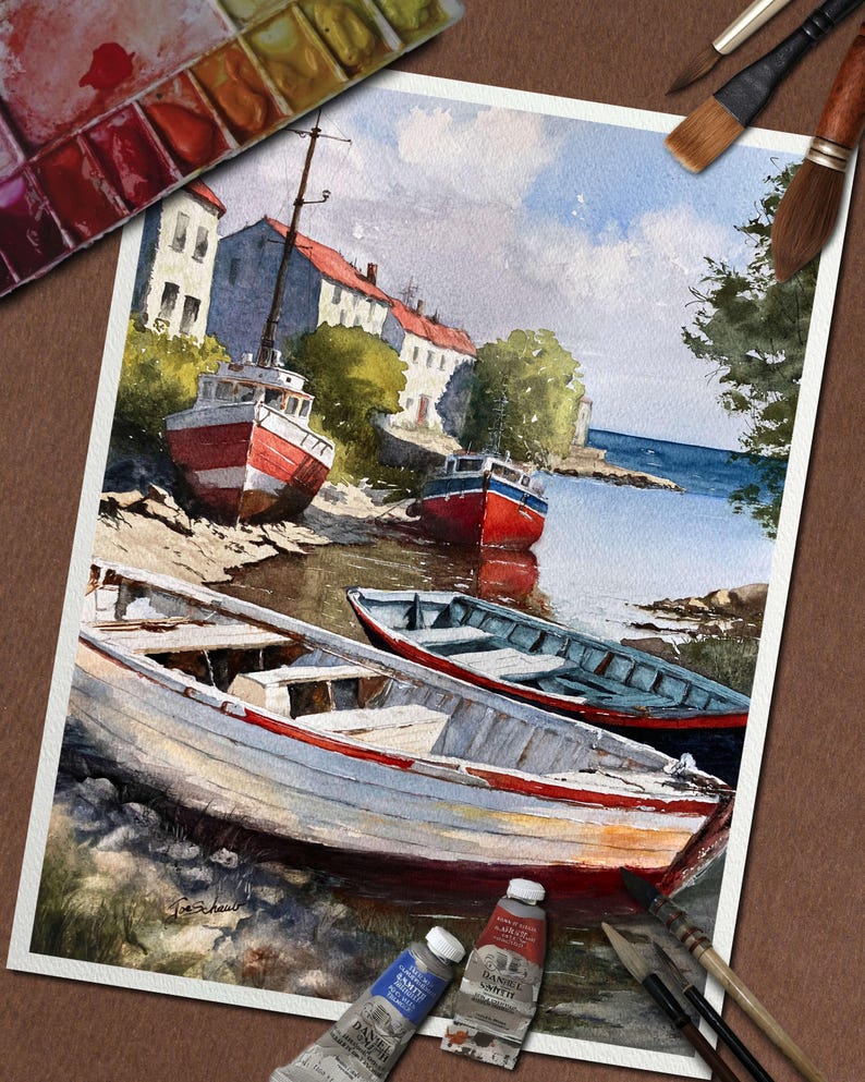May include: Watercolor painting of boats on a shore with buildings in the background. The boats are red, white, and blue. The painting is on a white paper with paint tubes and brushes around it.