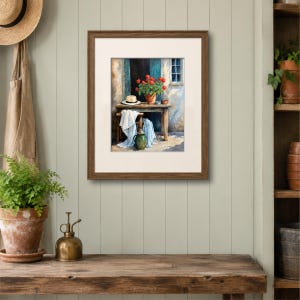 May include: A framed painting depicting a rustic outdoor scene with a wooden table, a potted plant with red flowers, a straw hat, and a white cloth draped over a chair. A green pitcher sits on the ground near the table, set against a textured wall.