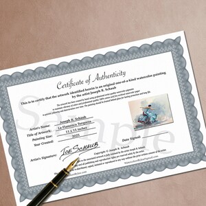 May include: A certificate of authenticity for a watercolor painting by Joseph R. Schaub. The certificate includes the painting's title, "La Flamenca Turquesa," and dimensions of 11 x 15 inches. A pen rests on the certificate.