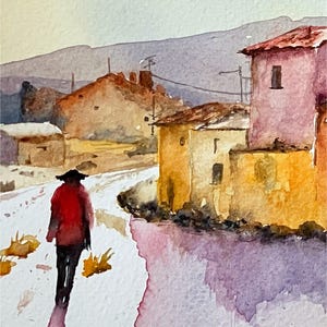 May include: Watercolour painting of a person in a red jacket walking along a road in a village. Buildings are painted in yellow, orange, and pink. A mountain range is in the background. The artwork has a soft, impressionistic style.