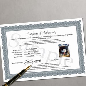 May include: A white Certificate of Authenticity document with a grey decorative border, featuring the text Certificate of Authenticity, artist Joseph R. Schaub, and a small watercolor painting of a boat. A black fountain pen rests on the document.