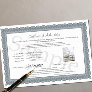 May include: A Certificate of Authenticity for an original watercolor painting by Joseph R. Schaub titled Low Tide, Gloucester. The document features a gray decorative border, a small image of the painting, and a black fountain pen resting nearby.