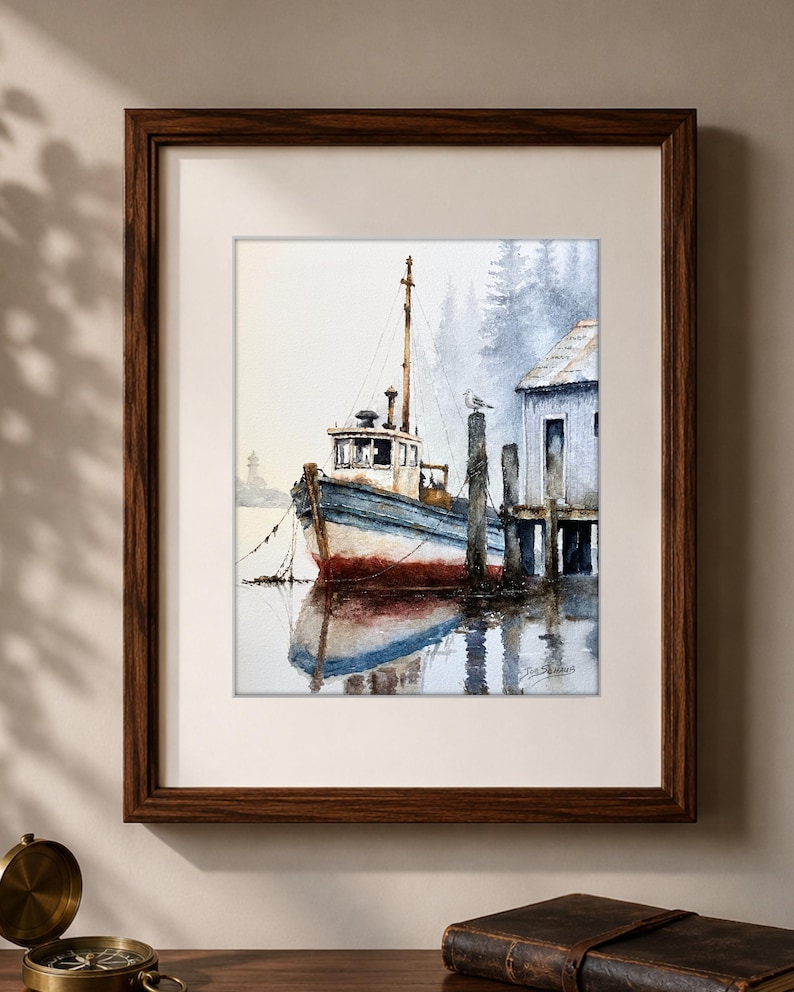 May include: A framed watercolor painting depicting a blue and white fishing boat moored at a wooden dock. The scene features a seagull perched on a piling, a small building on the right, and a misty forest background with a reflection in the water.
