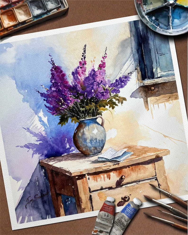 May include: Watercolor painting of a still life featuring a bouquet of purple flowers in a blue vase on a wooden table. A small book rests on the table, with paint tubes and brushes nearby. The artwork has a soft, natural light.