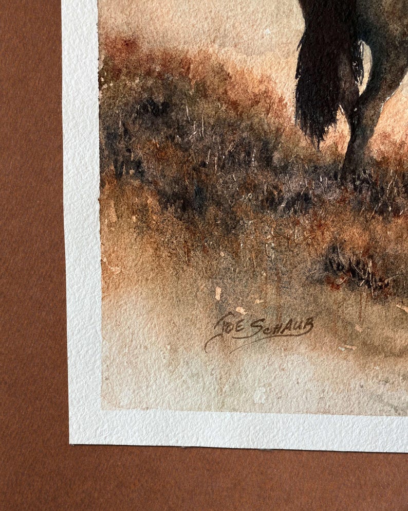 May include: Watercolor painting of a landscape with a tree and tall grass. The artwork is signed "Joe Schaub" in the lower right corner. The painting is framed with a white border and a brown mat.