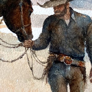 May include: Watercolor painting of a cowboy with a horse. The cowboy wears a hat, dark shirt, and jeans, with a detailed belt. The horse is brown. The artwork has a soft, muted color palette.