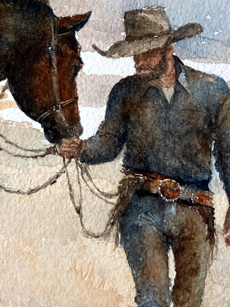 May include: Watercolor painting of a cowboy with a horse. The cowboy wears a hat, dark shirt, and jeans, with a detailed belt. The horse is brown. The artwork has a soft, muted color palette.