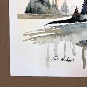 May include: A watercolor painting on textured paper depicting a landscape with dark green and black evergreen trees along a shoreline. The water features gray and brown washes with vertical drips. The artist signature Joe Schaub is in black ink.